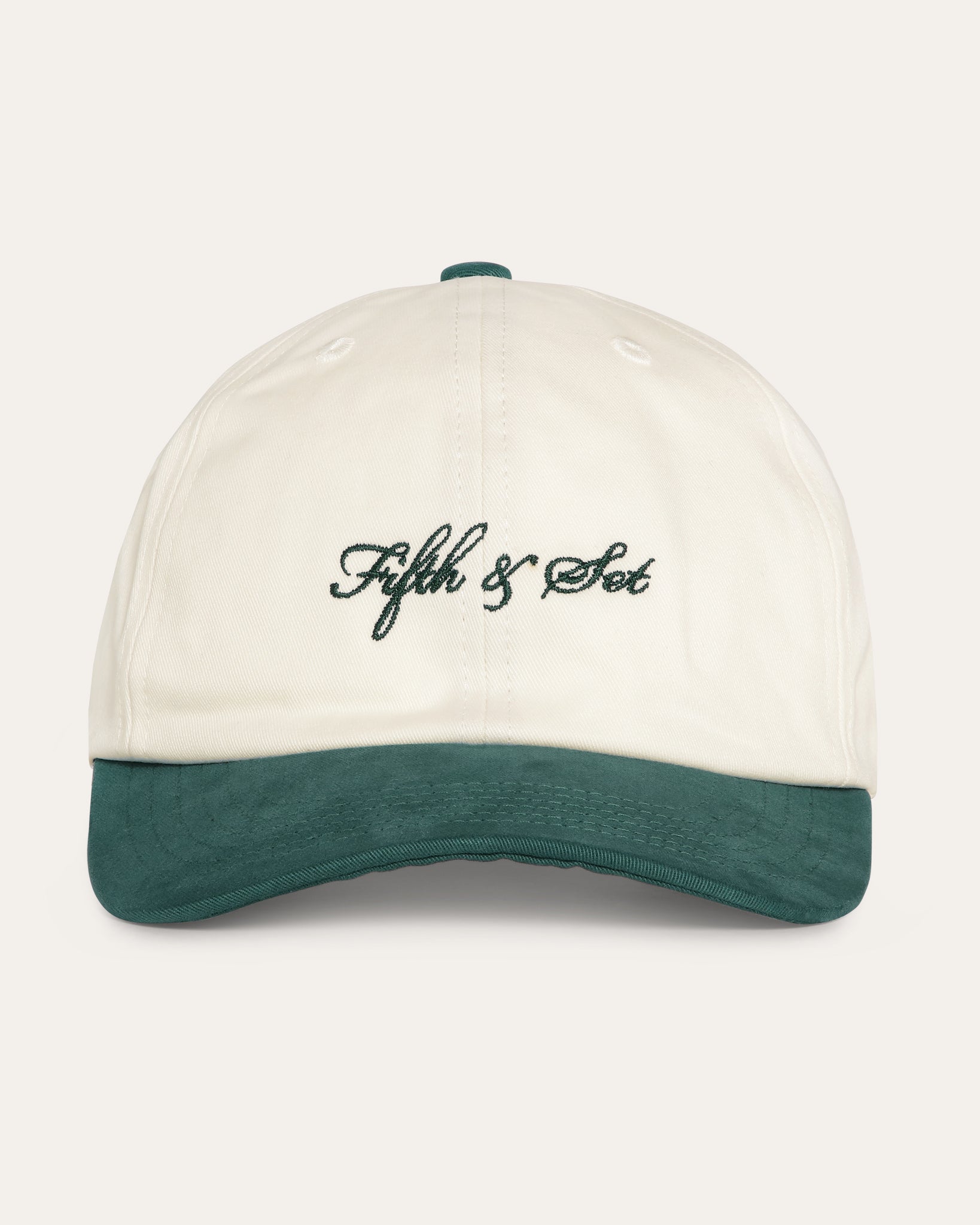 Cap in dark green and beige with dark green embroidered logo on the front.