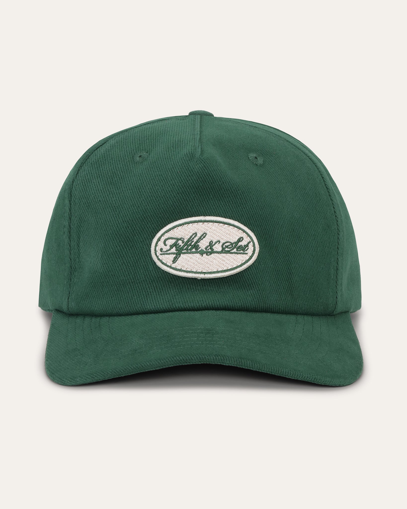 Green cap with a logo on a light gray background