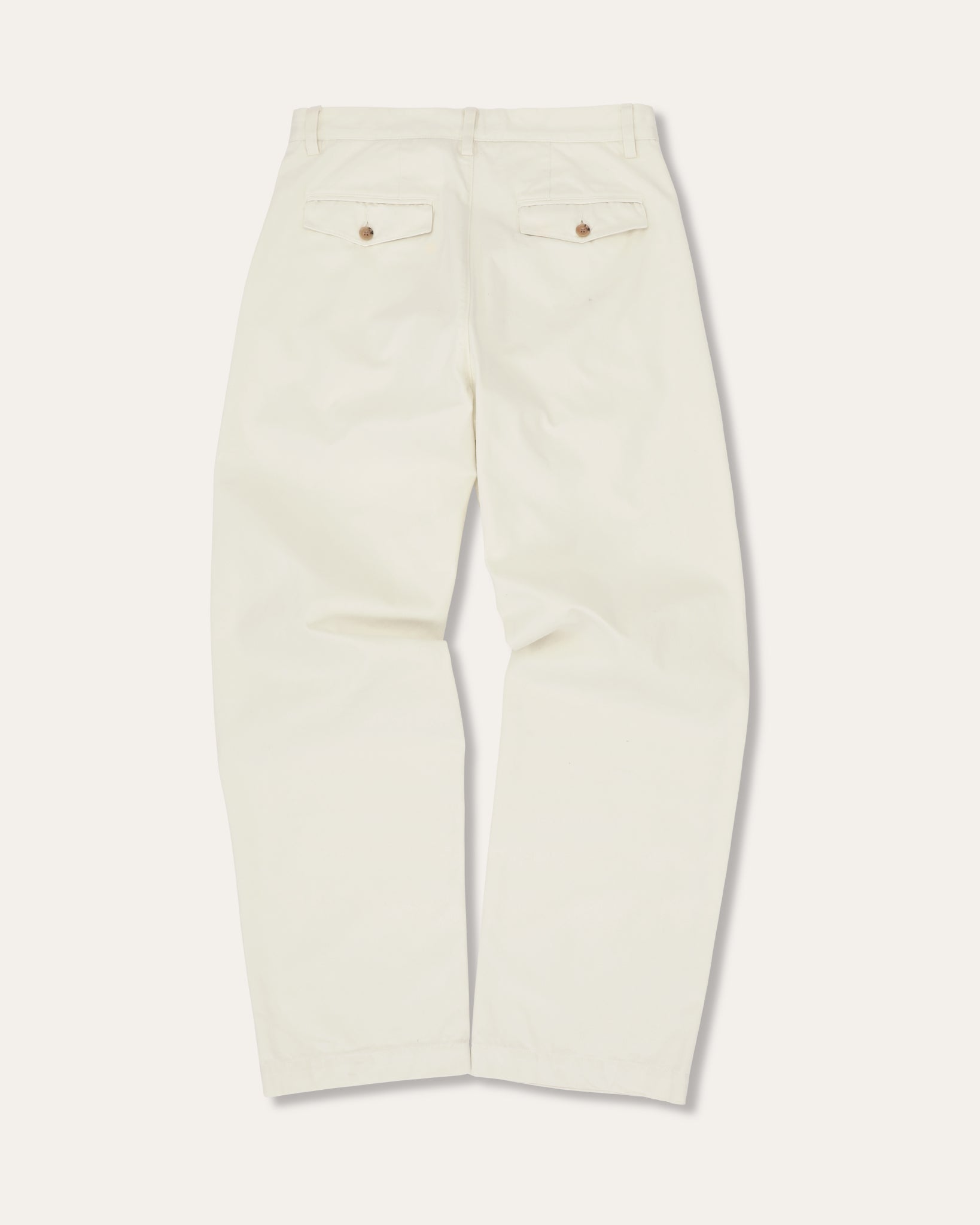White chino trousers on a white background