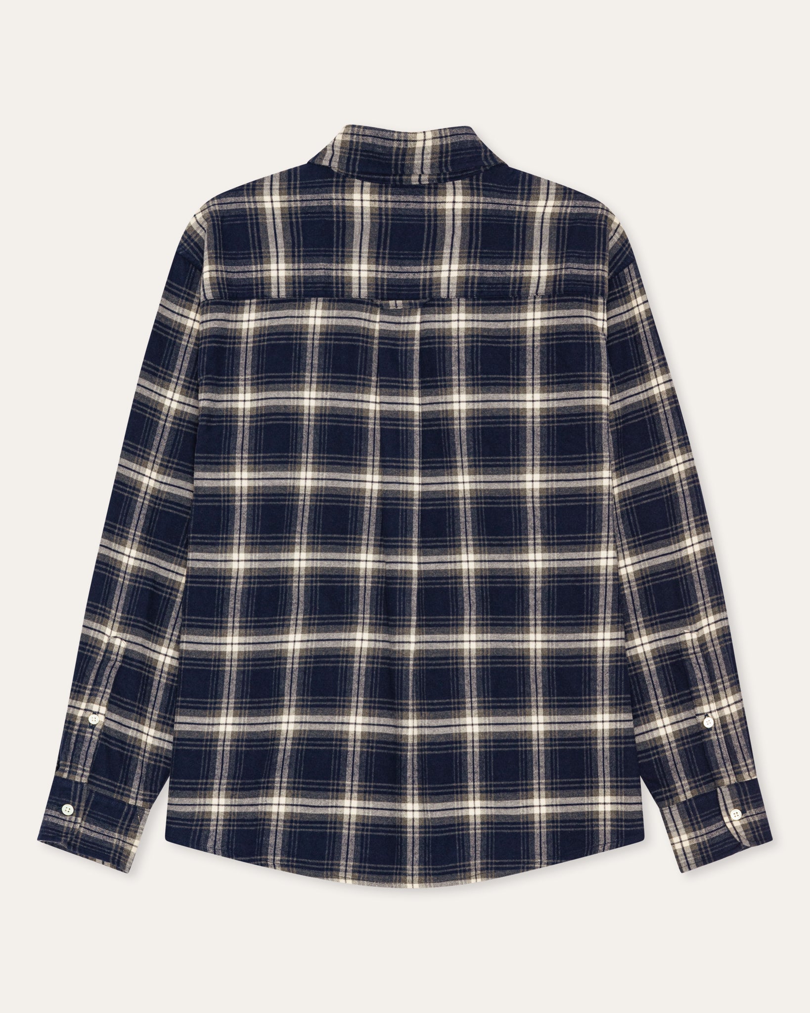 A long-sleeve plaid button-up shirt shown flat against a light off-white background. The shirt features a dark navy blue base with a cream and white plaid pattern.