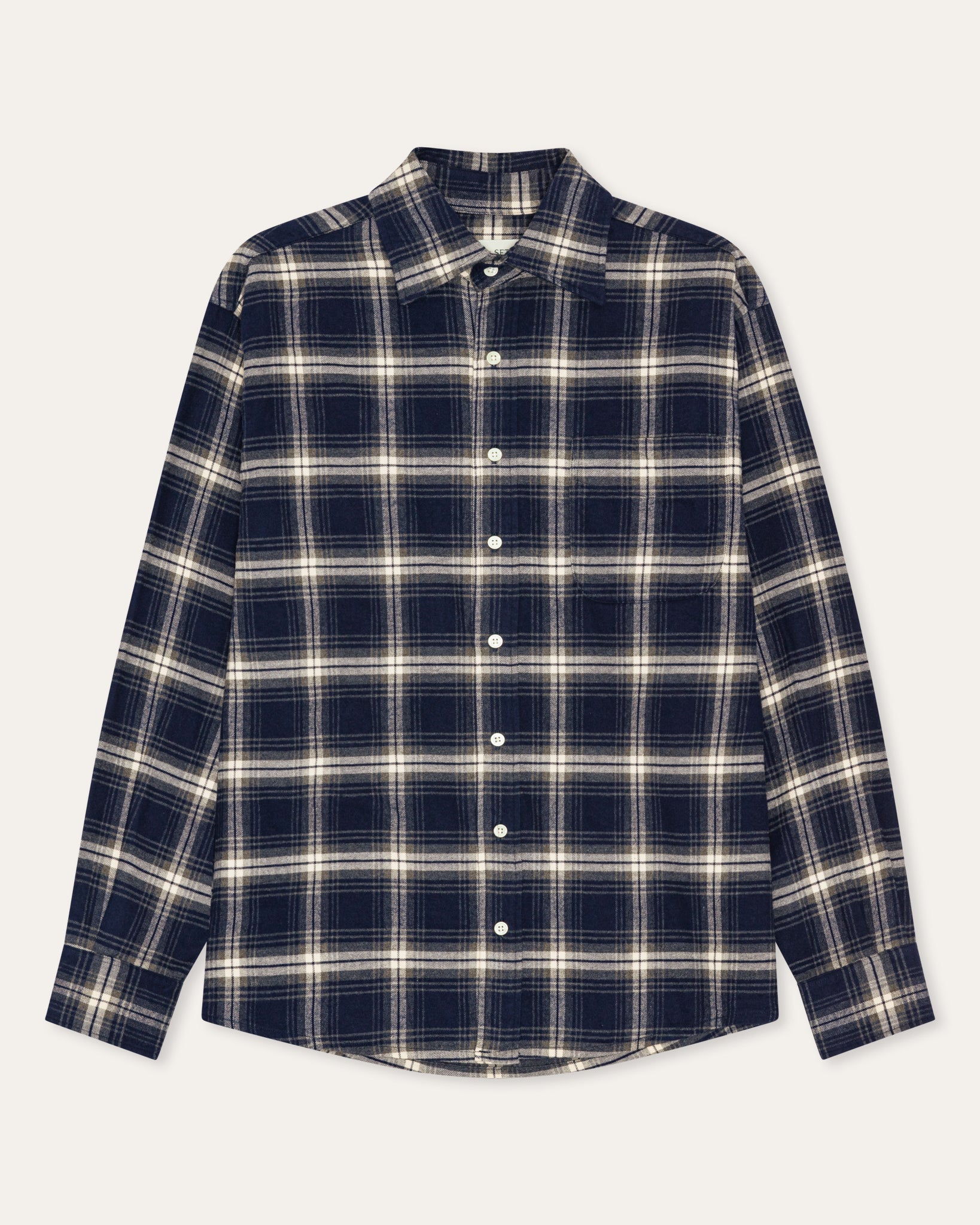 A long-sleeve button-up plaid shirt in navy blue and cream, laid flat against a light off-white background.