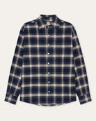 A long-sleeve button-up plaid shirt in navy blue and cream, laid flat against a light off-white background.