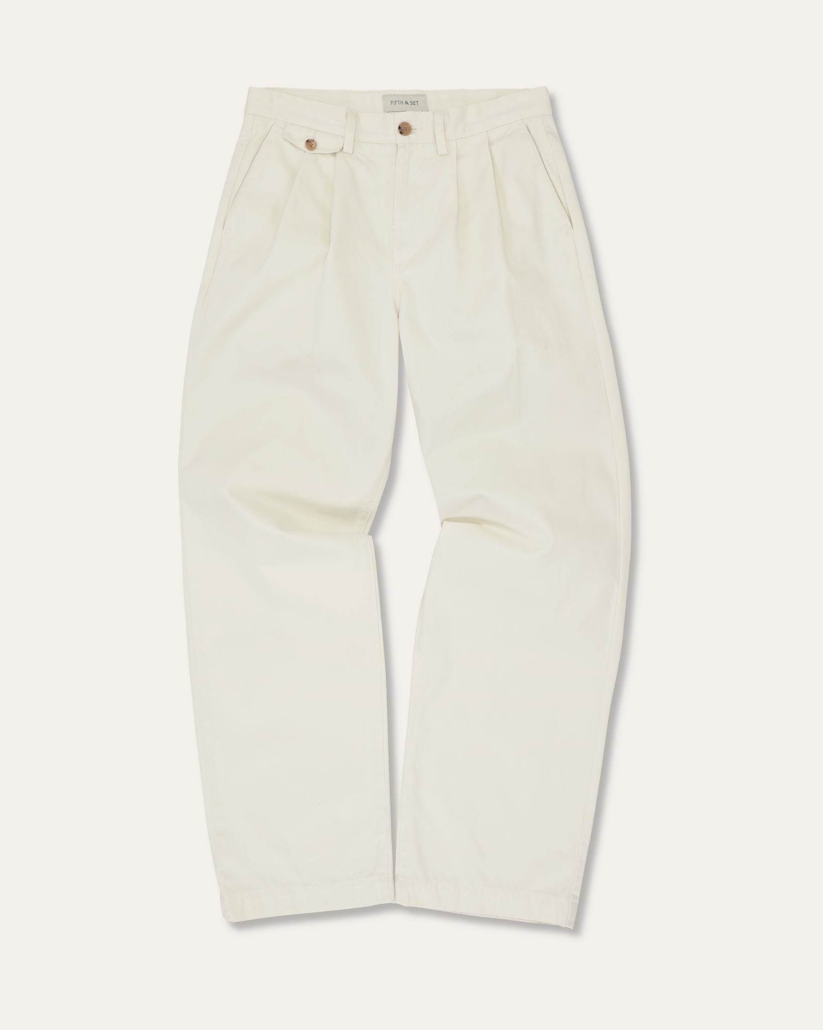 Cream pleated pants on a white background